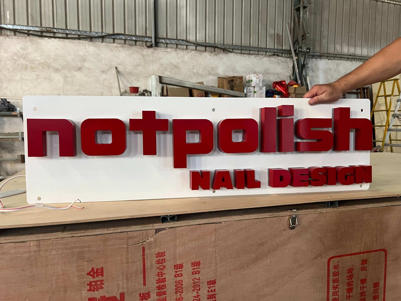 Daylight unlit inspection of Not Polish 3D metal signage
