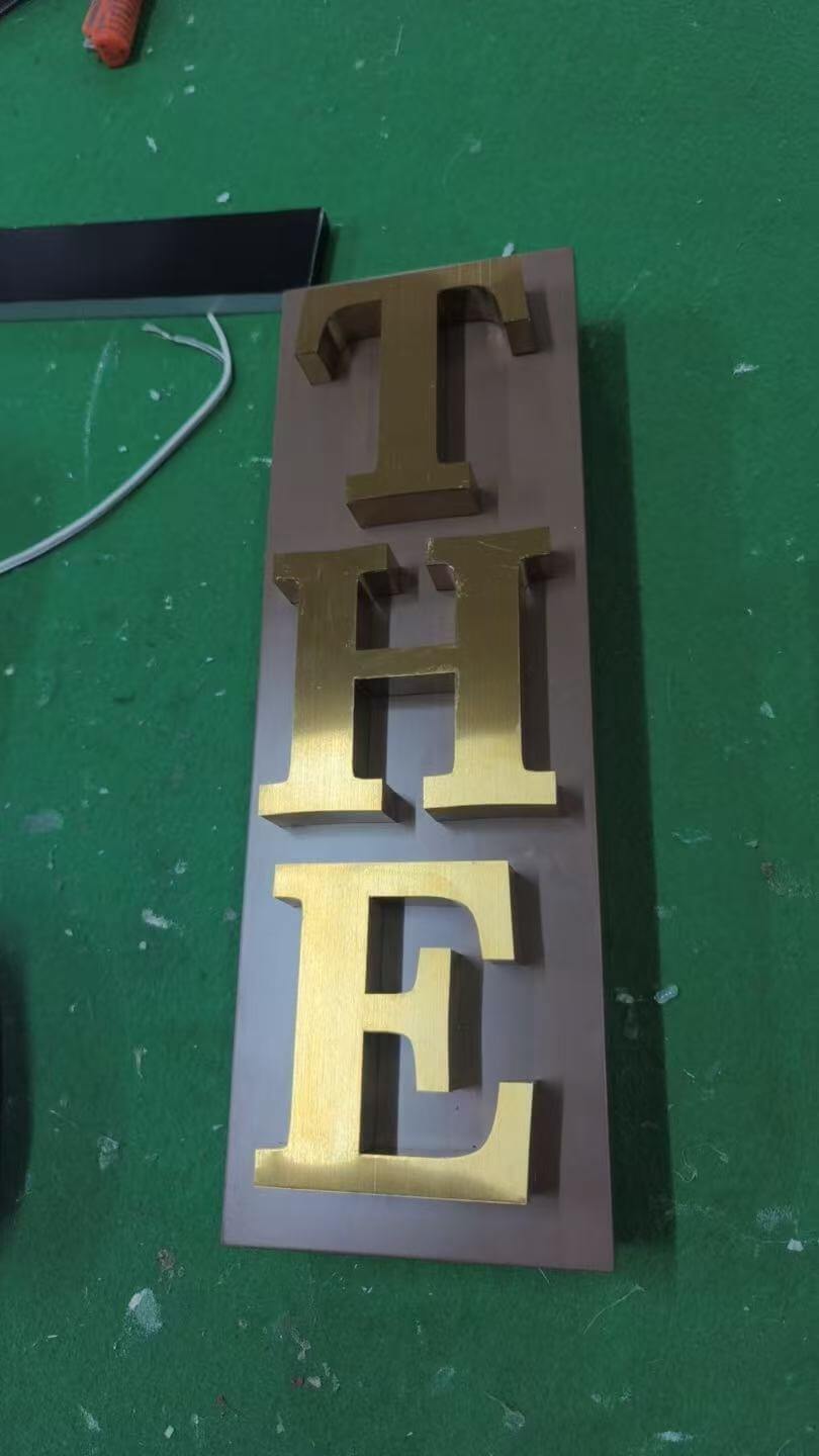 Finished vertical THE accent sign with gold metal trim