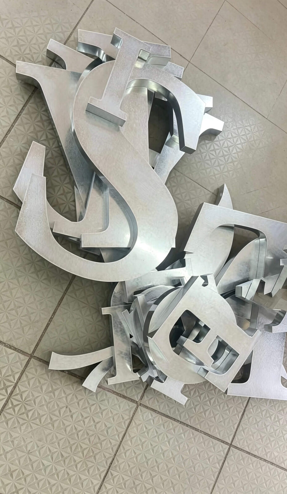 Laser cut galvanized steel letter shells prior to assembly
