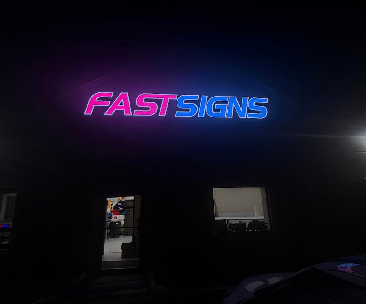 Installed FASTSIGNS custom dynamic rgb channel letters nighttime glowing storefront photo