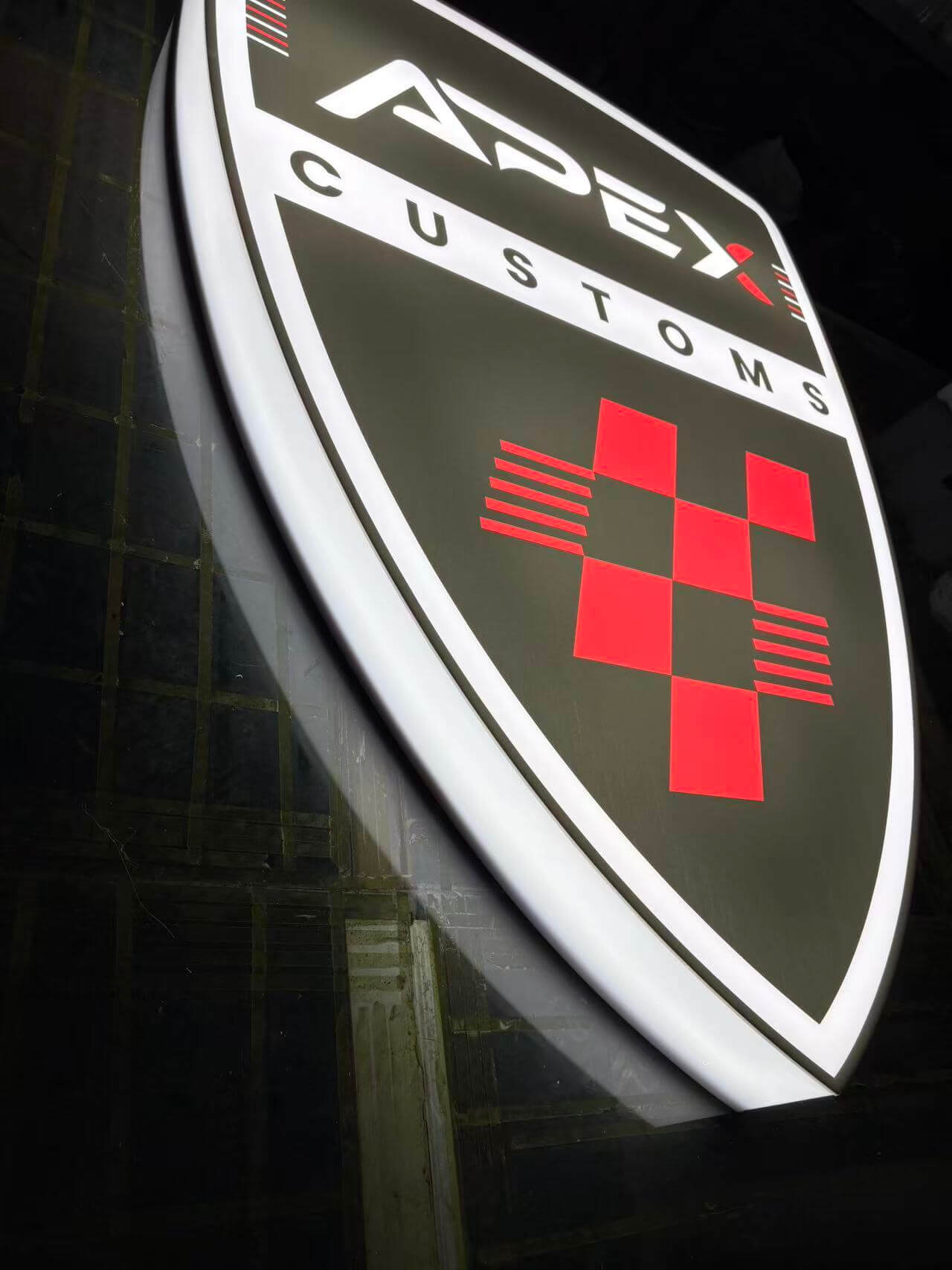 Custom shield light box sign darkroom edge glow testing at EndPoint Sign's Guangzhou engineering center