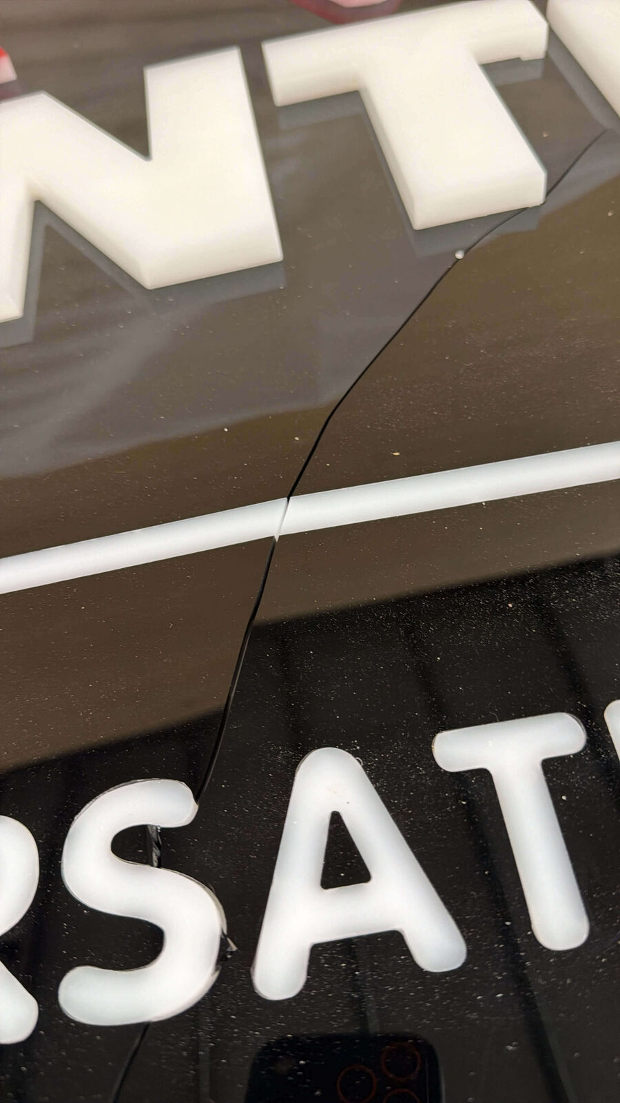 Close up inspection of damaged corporate sign lettering