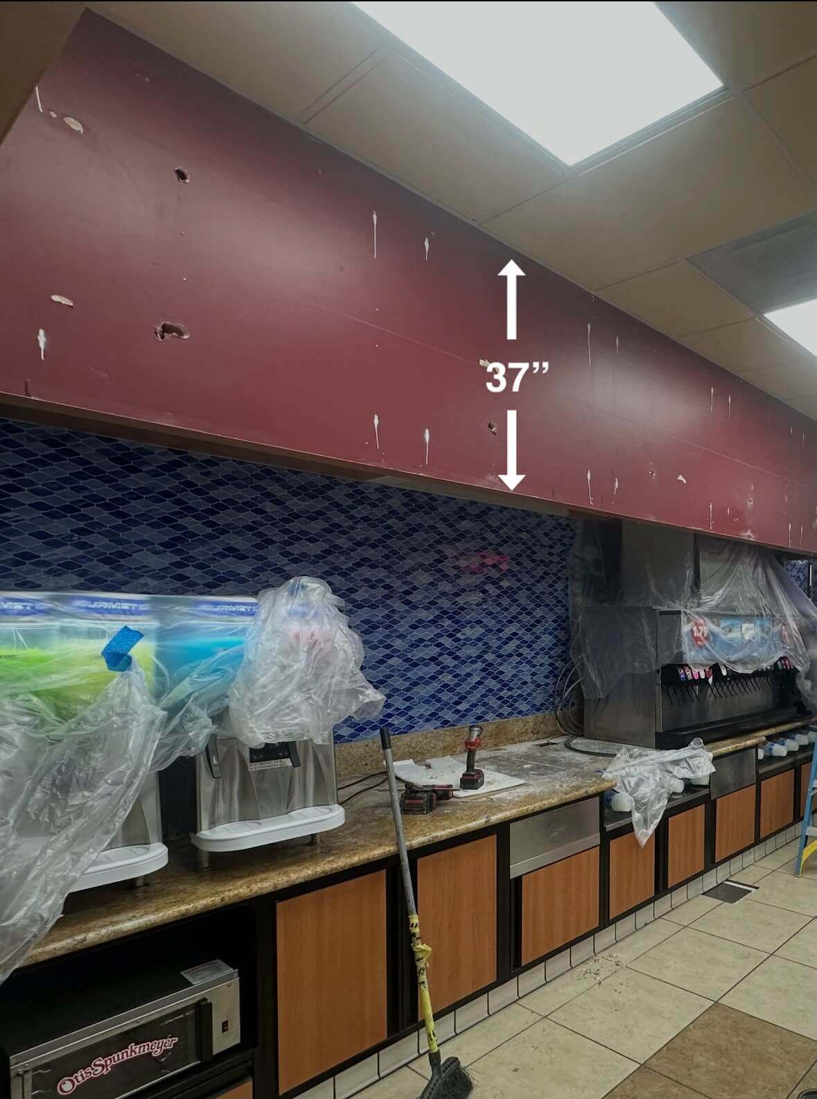 Site survey measuring 35-inch clearance for wall mounted backlit channel letters