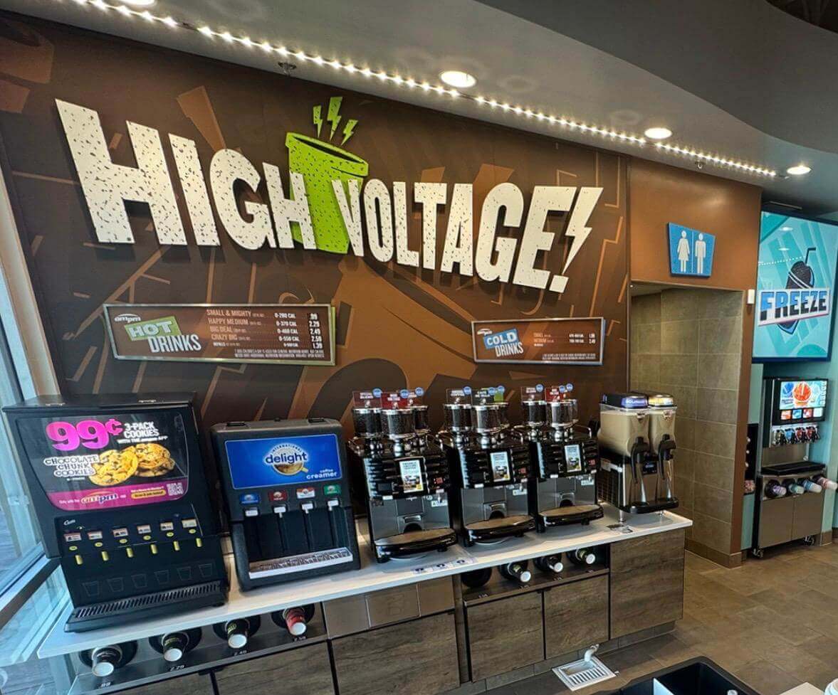 Convenience store drink dispenser counter showing ambient interior illumination and wall panels