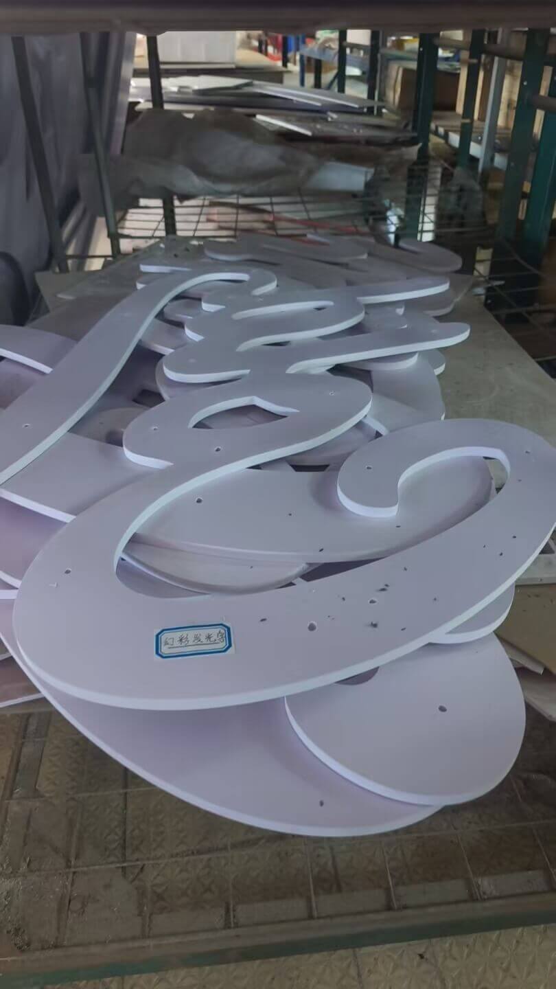 Laser-cut acrylic letter returns stacked at EndPoint Sign's Guangzhou fabrication plant