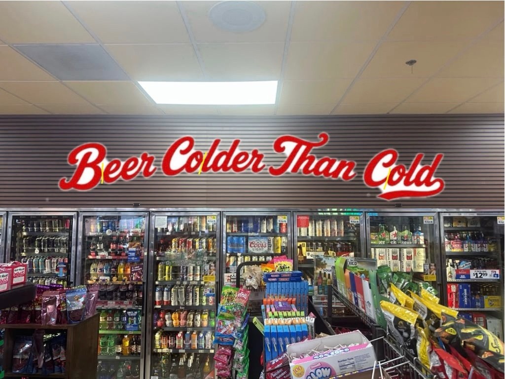Beer cave signs — Beer Colder Than Cold cooler sign in a convenience store