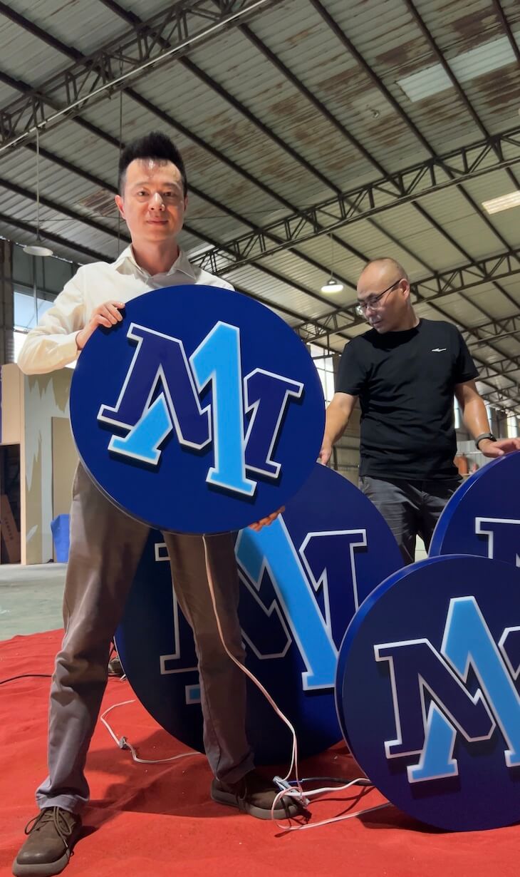 Inspection of custom round LED signs prior to heavy duty wooden crate packaging